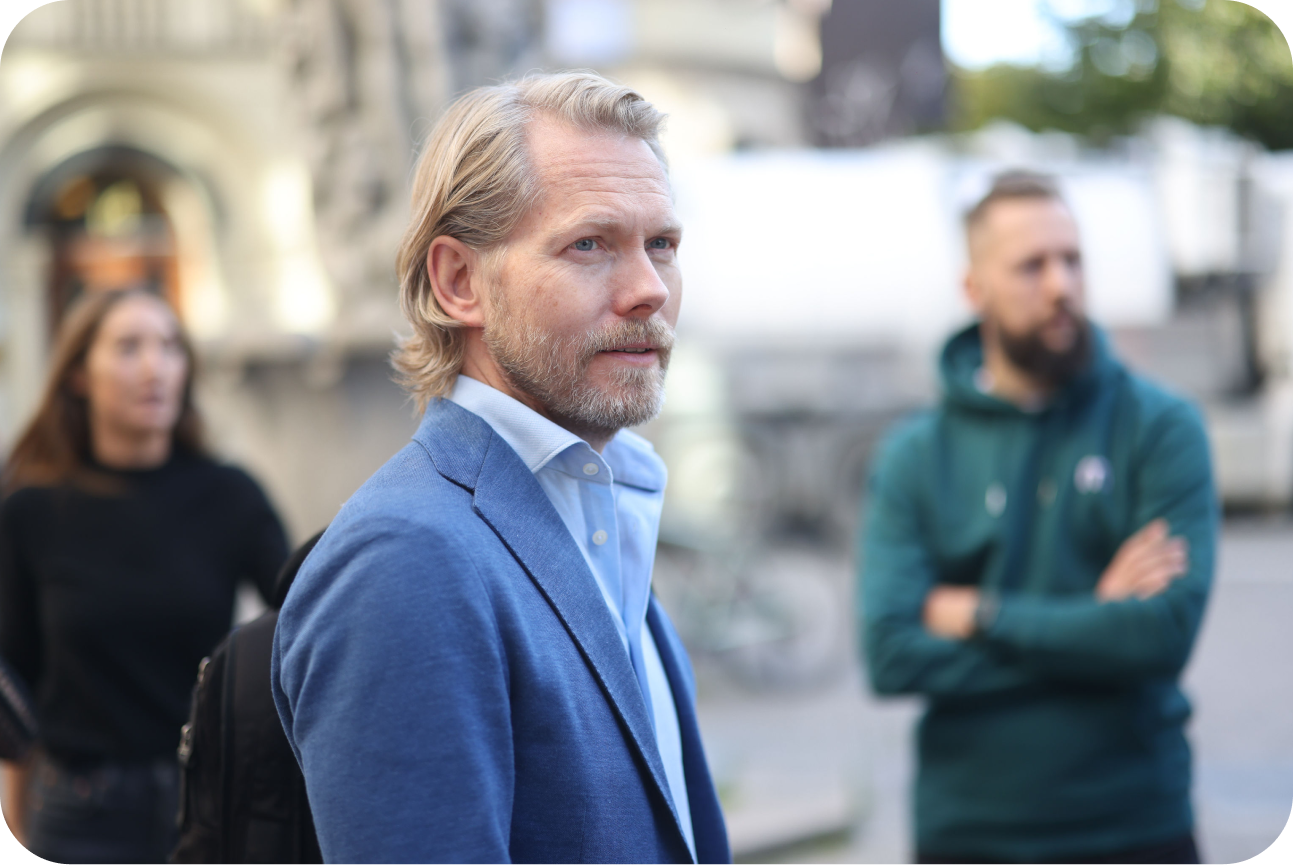 Michael Hansen outside with some of the Monto team members in the background